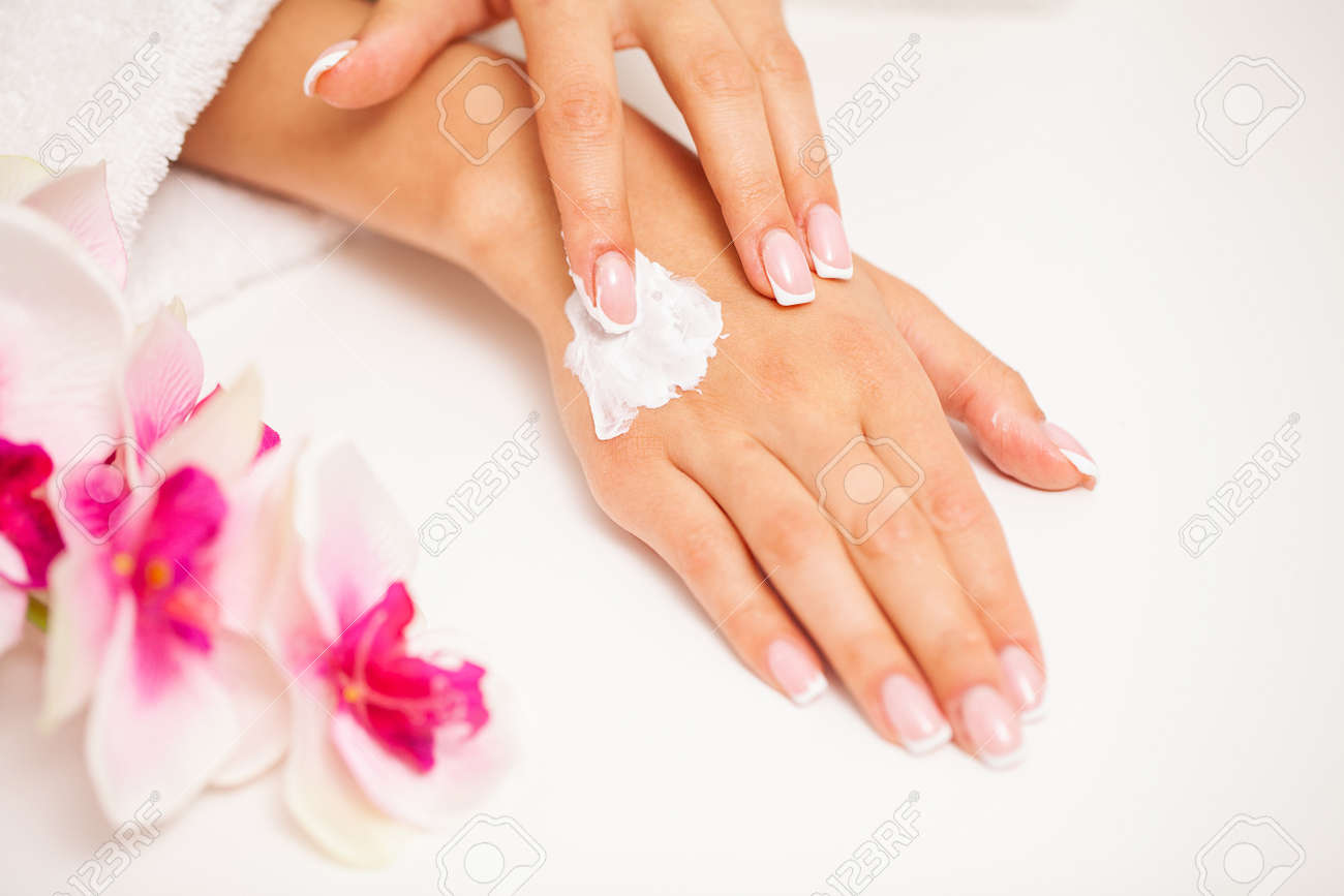 Woman use skin care products at home in light bathroom - 166858881 Woman use skin care products at home in light bathroom - 166858881