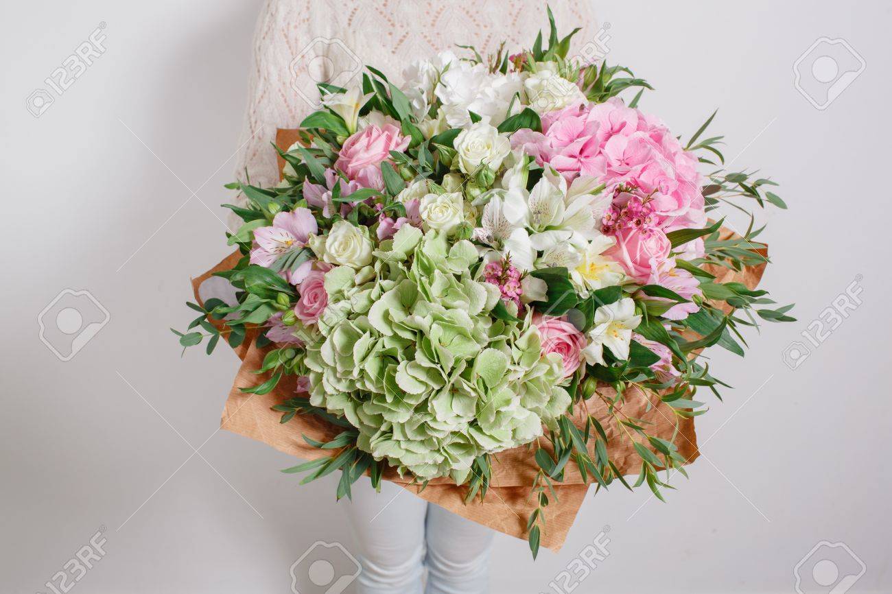 Florist at work. Make hydrangea rich bouquet. colorful roses - 62890231 Florist at work. Make hydrangea rich bouquet. colorful roses - 62890231