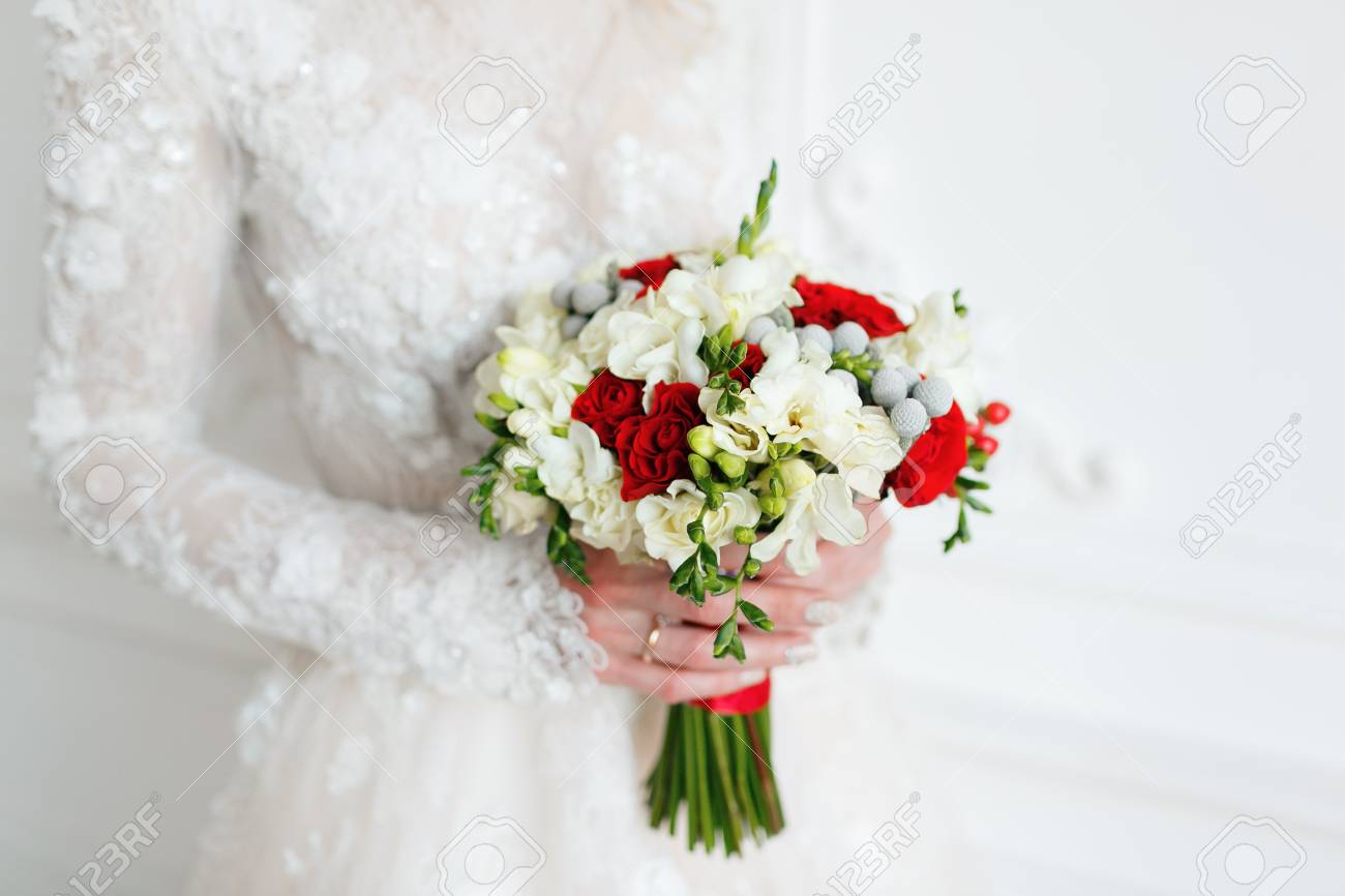 Bride Holding Bridal Bouquet Close Up Red And White Roses