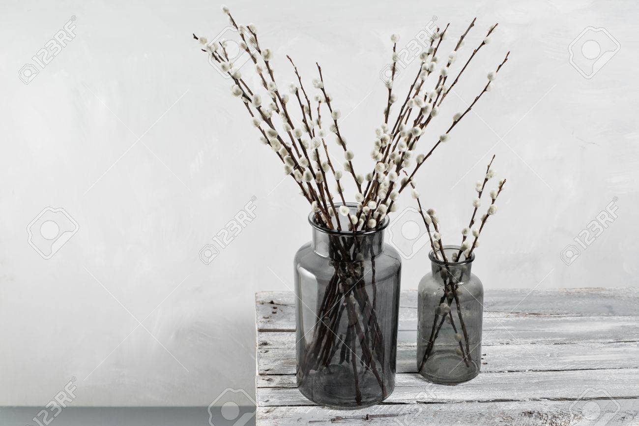 Willow Branches In Glass Vases On A Wooden Gray Table Top