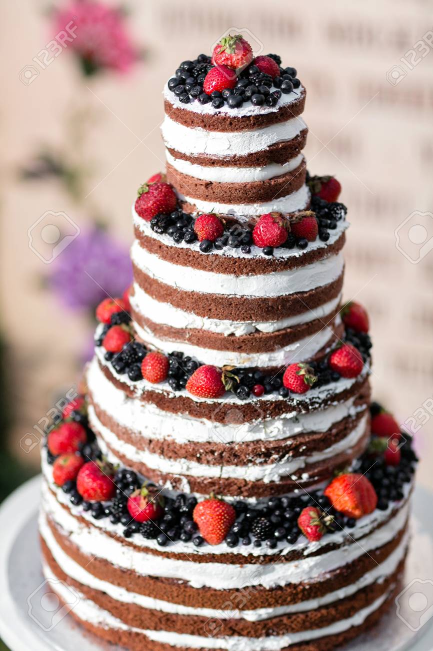round multi tiered wedding cake with sponge cream jam and berries multitiered