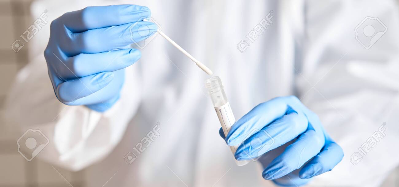 Doctor holding swab test tube for 2019-nCoV analyzing. Coronavirus test. Blue medical gloves and protective face mask for protection against covid-19 virus. Coronavirus and pandemic. - 144854362 Doctor holding swab test tube for 2019-nCoV analyzing. Coronavirus test. Blue medical gloves and protective face mask for protection against covid-19 virus. Coronavirus and pandemic. - 144854362