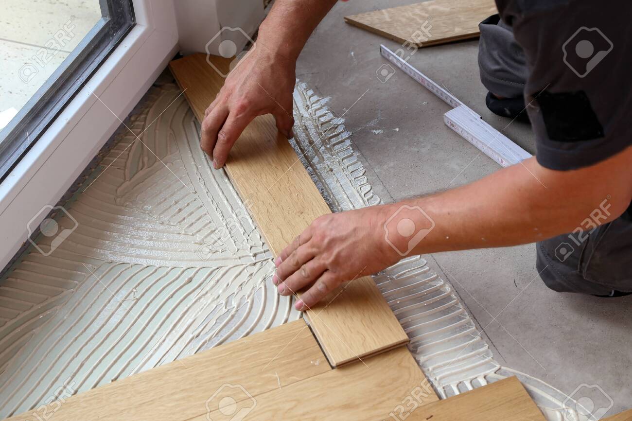 Worker Laying Parquet Flooring Worker Installing Wooden Laminate