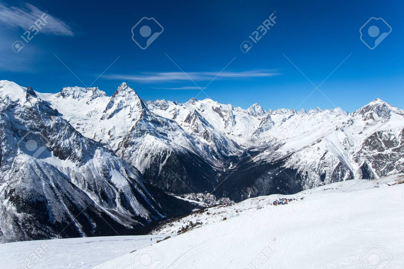Snow Capped Alpine Mountain Ranges Extending Into The Distance And The Village Below Panorama Snow Capped Alpine Mountain Ranges Extending Into The Distance And The Village Below Panorama