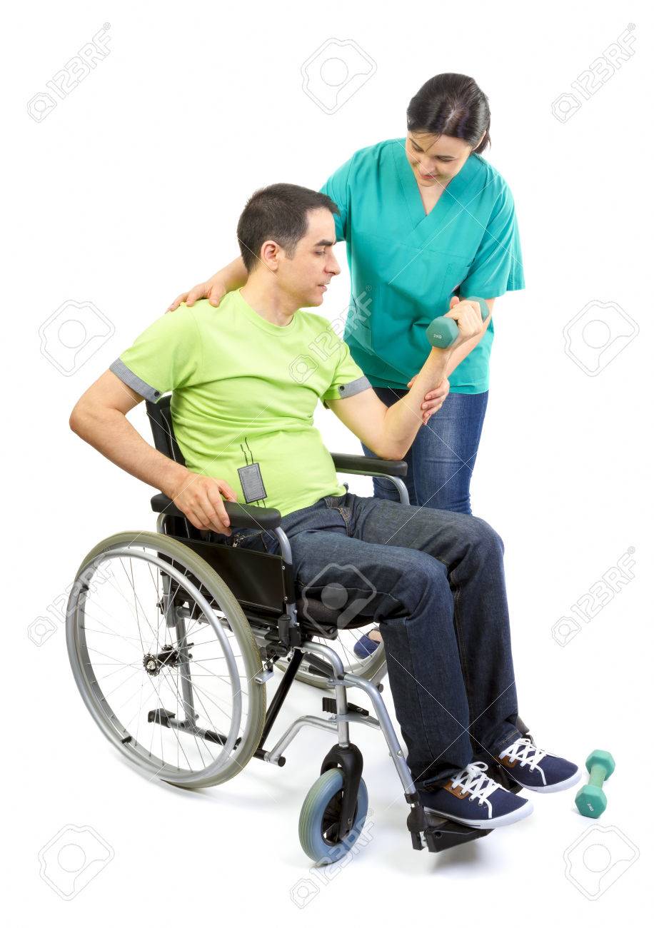 Physical therapist works with patient in lifting hands weights Young adult in wheelchair - 30165563 Physical therapist works with patient in lifting hands weights Young adult in wheelchair - 30165563