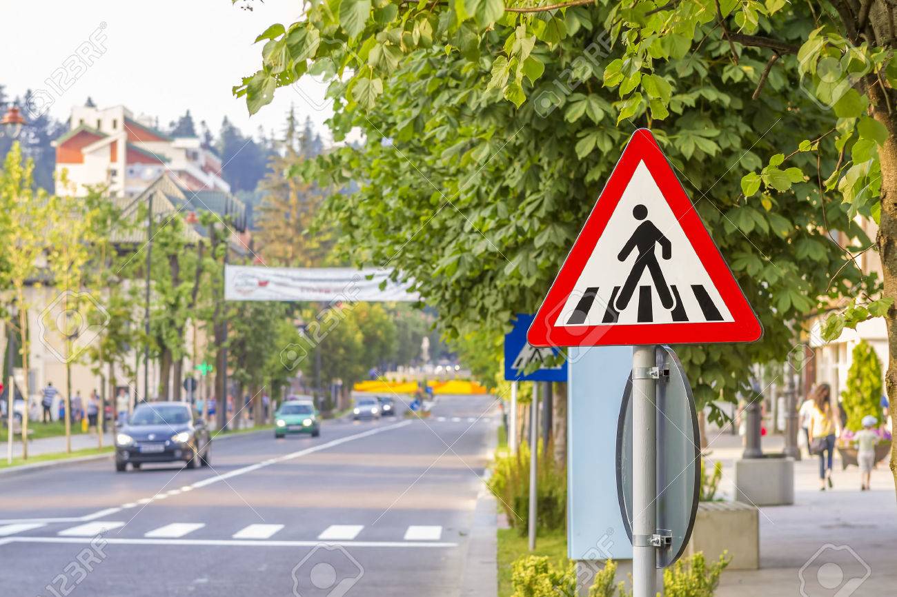 Pedestrian crossing road traffic sign showing a person on a zebra