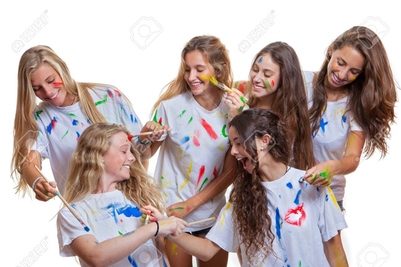 group of kids or teens girls having fun with messy paint stock photo