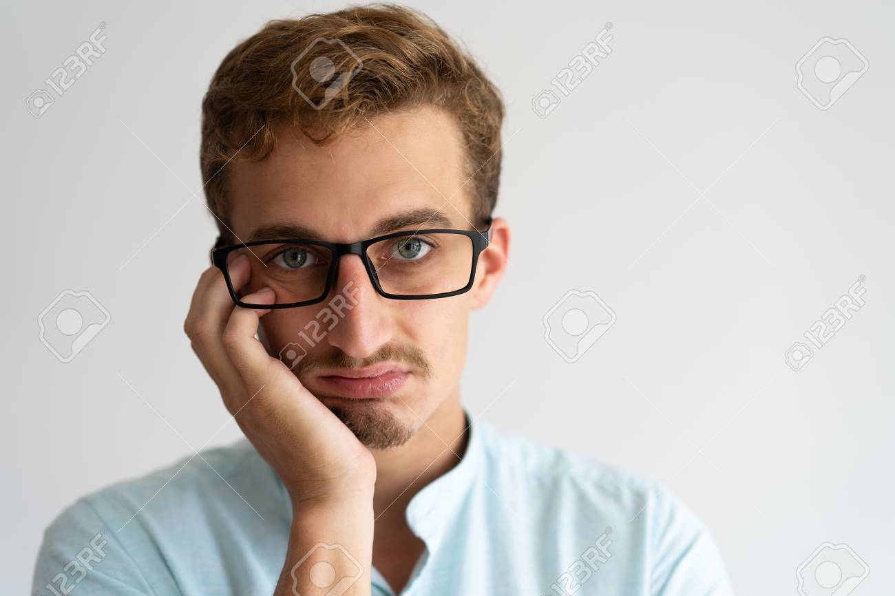 closeup of upset annoyed blonde guy with disgusted face bored