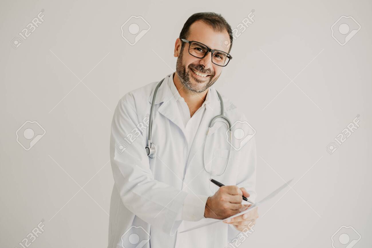 Portrait of successful general practitioner signing contract. Mid adult Caucasian doctor wearing lab coat, glasses and stethoscope making notes. Prescription or contract concept - 112678399 Portrait of successful general practitioner signing contract. Mid adult Caucasian doctor wearing lab coat, glasses and stethoscope making notes. Prescription or contract concept - 112678399