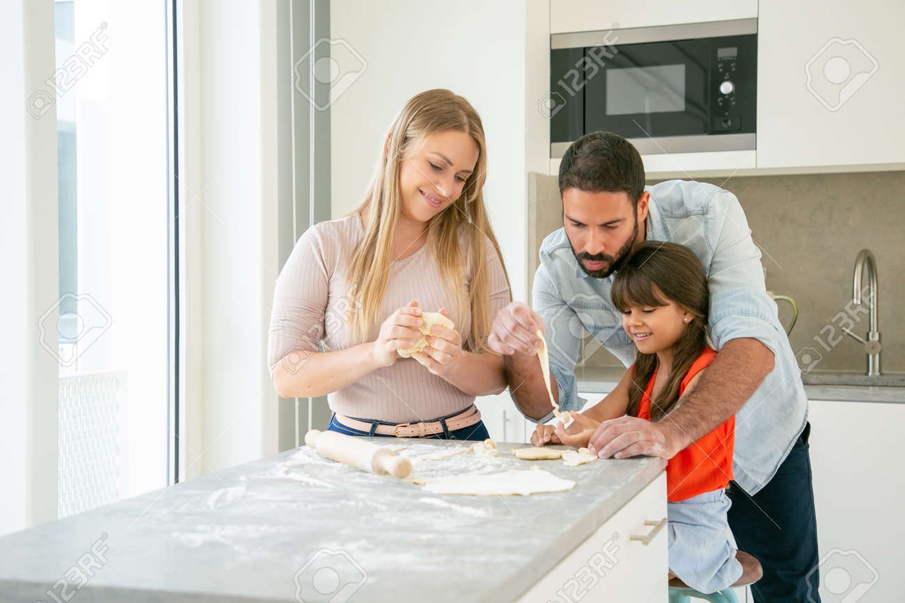 Dad Teaching Daughter To Knead Dough