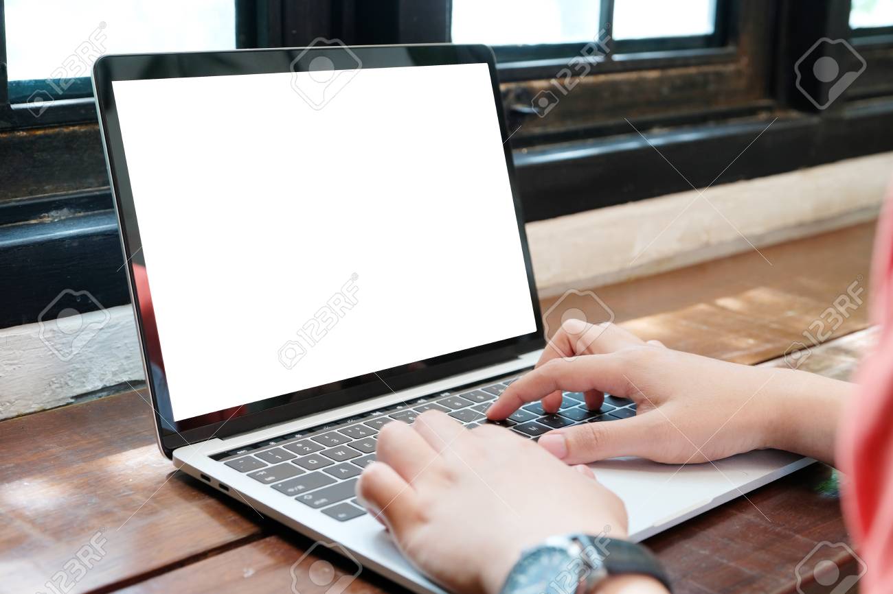 man hands typing laptop computer with blank screen for mock up