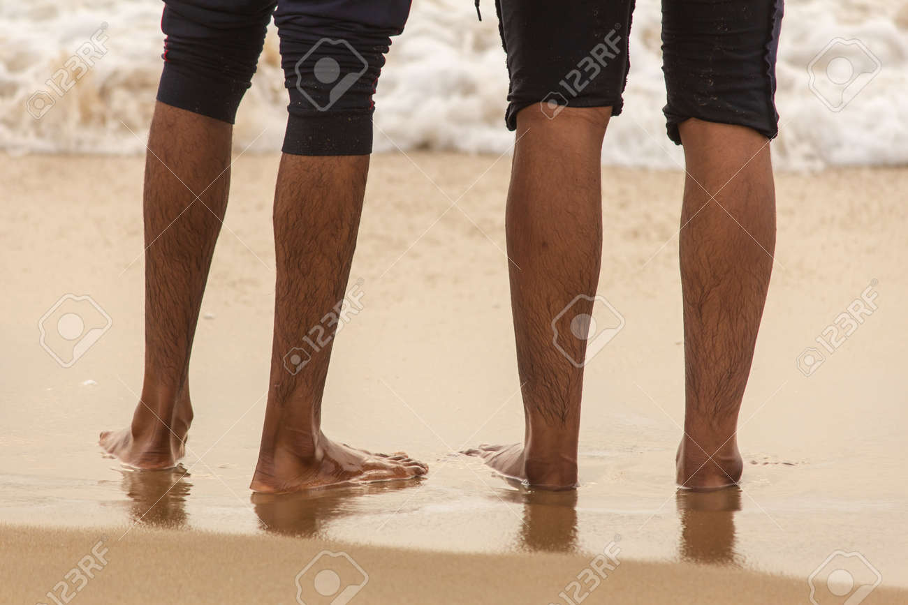 Friends enjoying the waves in the beach, Marina Beach, Chennai. Focus set on foot - 166741018 Friends enjoying the waves in the beach, Marina Beach, Chennai. Focus set on foot - 166741018