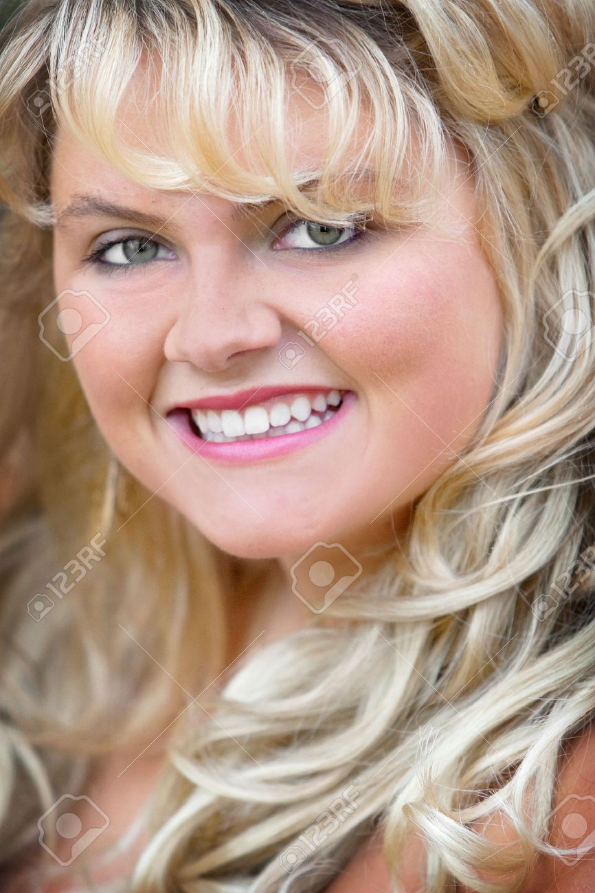 headshot portrait of a blonde young adult woman smiling gorgeous standard headshot size