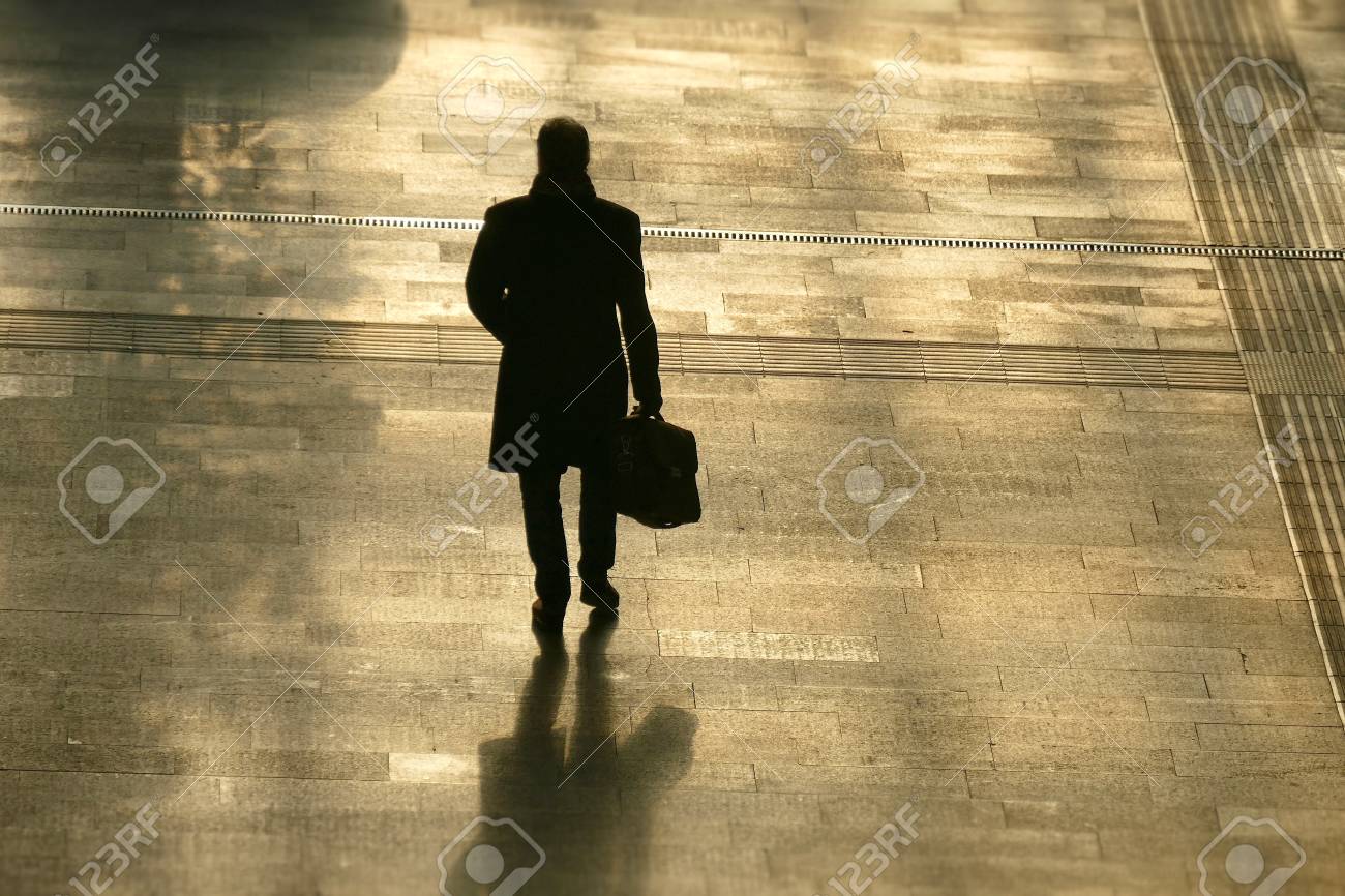 Silhouette Of Lonely Man Holding A Bag Walking Ahead Back View Stock Photo Picture And Royalty Free Image Image
