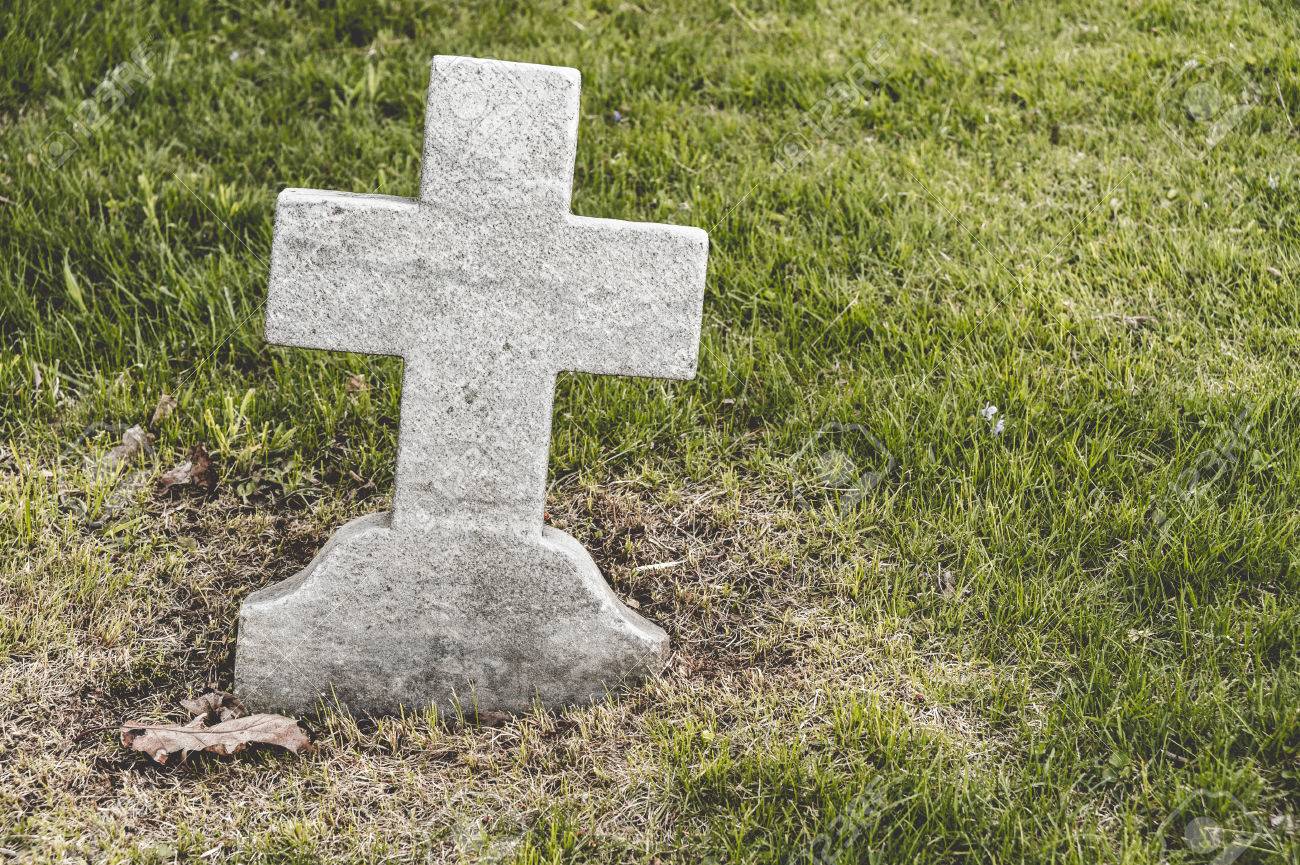 cross shaped blank headstone in a cemetery stock photo picture and