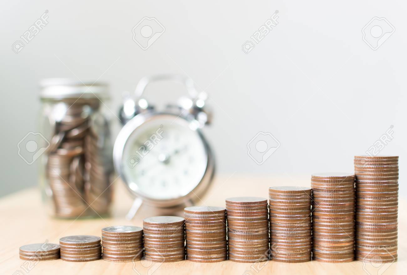 Coin stack step growing up to success financial business with clock and jar, Save money and investment concept, Copy space for your text - 93524415 Coin stack step growing up to success financial business with clock and jar, Save money and investment concept, Copy space for your text - 93524415