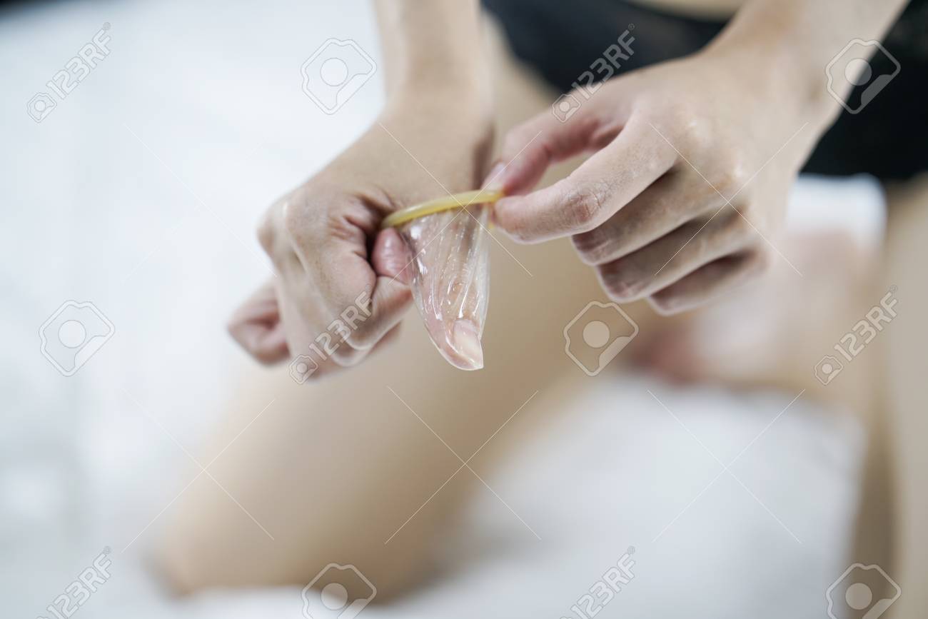 Close Up Of A Young Girl Holding An Open Condom Safe Sex Concept  