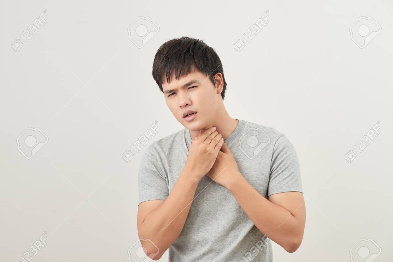 Standard-Bild - Young Asian man having sore throat / throat related diseases Young Asian Man Having Sore Throat / Throat Related Diseases ...