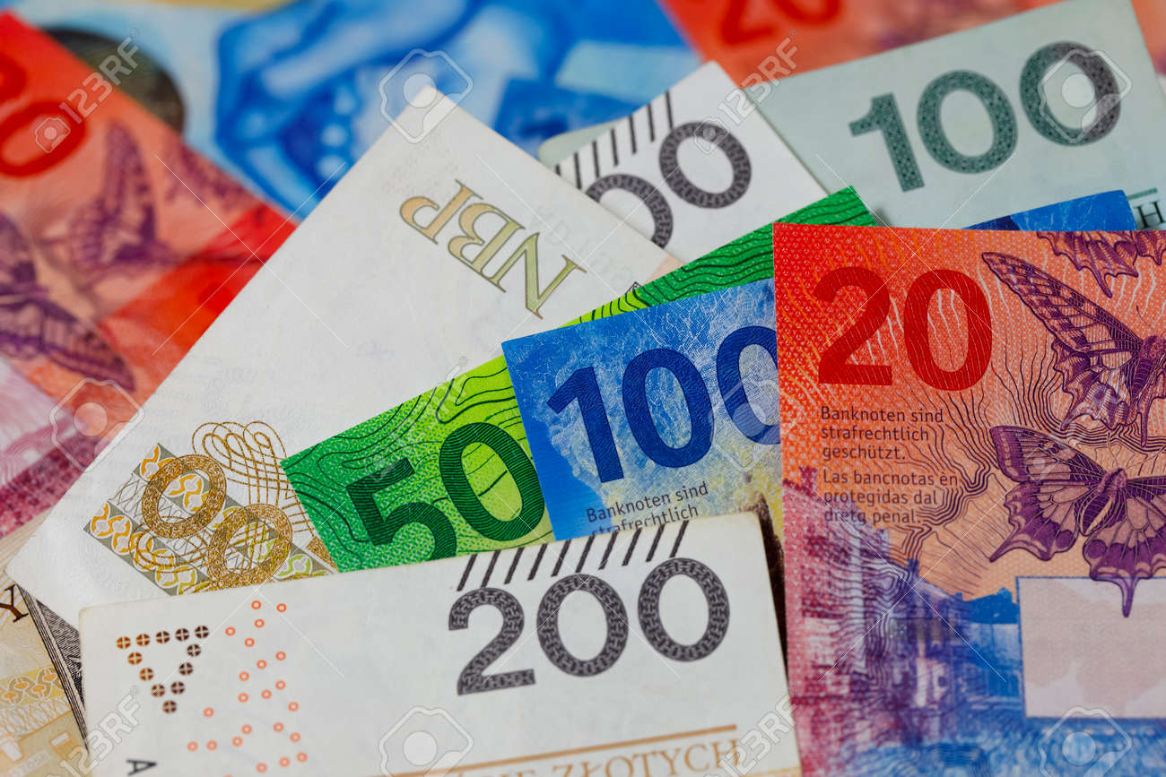 スイスとポーランドのお金。ポーランドズウォティとスイスフランの紙幣は隣り合って配置され、現在ではさまざまな金融問題の背景となっています。  PLNおよびCHF通貨の写真素材・画像素材 Image 180477027