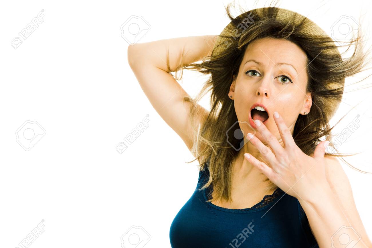 Expressive blonde woman summer tourist wears blue singlet holds hat because of wind - gesture of windy weather - concept on white background - 123222010 Expressive blonde woman summer tourist wears blue singlet holds hat because of wind - gesture of windy weather - concept on white background - 123222010