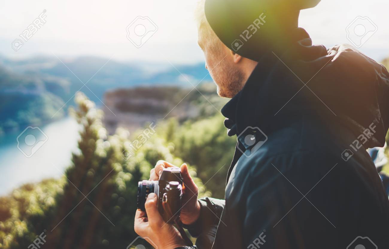 hipster tourist hold in hands taking photography click on retro vintage photo camera in auto, photographer looking on camera technology, hobby content, sun flare mountain, panoramic landscape vacation concept - 121168059 hipster tourist hold in hands taking photography click on retro vintage photo camera in auto, photographer looking on camera technology, hobby content, sun flare mountain, panoramic landscape vacation concept - 121168059