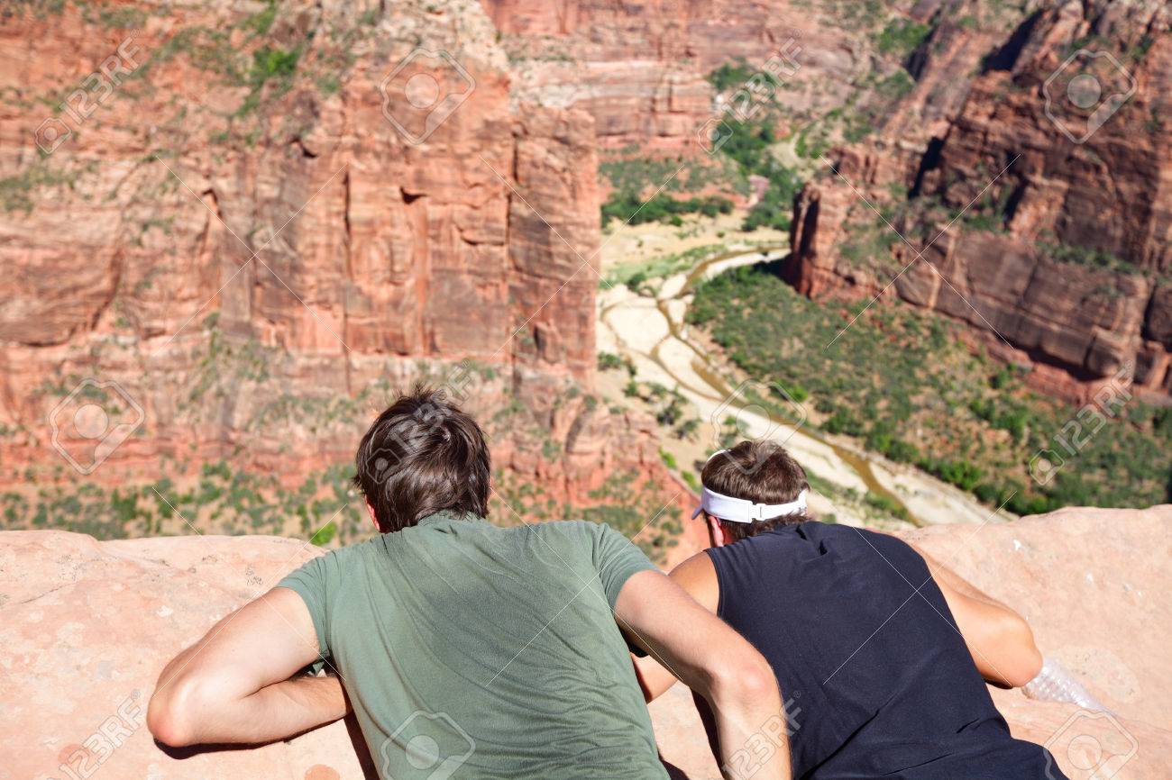 hikers at angels landing observation point looking down zion stock