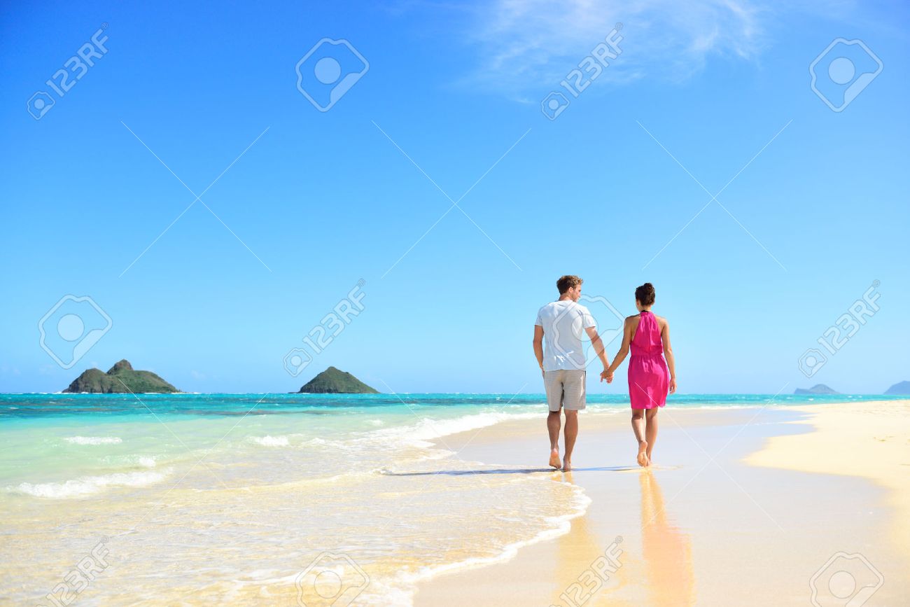46324117-Beach-honeymoon-couple-holding-hands-walking-on-white-sand-beach-Newlyweds-happy-in-love-relaxing-on-Stock-Photo.jpg