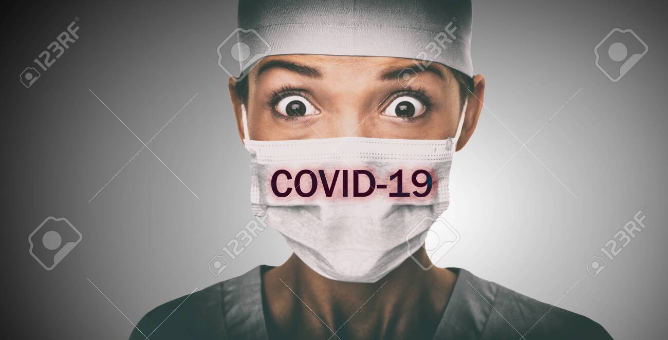 Covid-19 coronavirus text written over doctor surgical face mask Asian woman hospital worked scared shocked by Corona virus pandemic worried. Title on background. - 141627053 Covid-19 coronavirus text written over doctor surgical face mask Asian woman hospital worked scared shocked by Corona virus pandemic worried. Title on background. - 141627053
