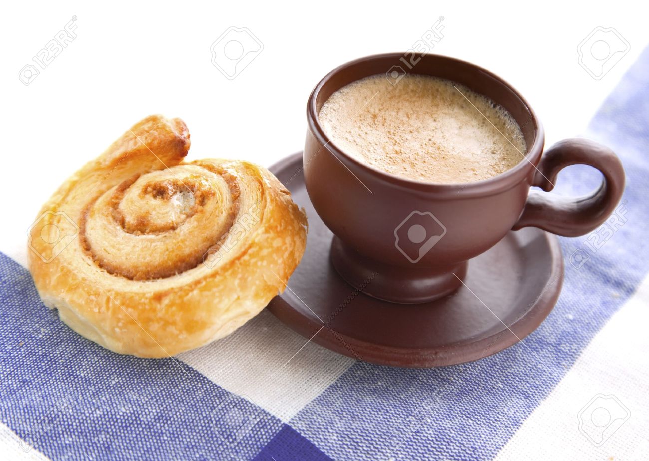 cup of cofee with cinnamon danish bun on textile background stock cofee