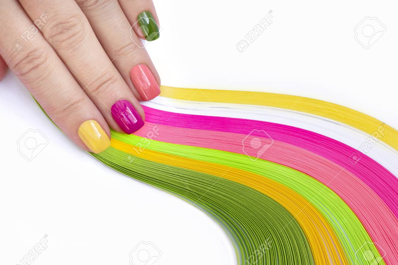 colorful multi colored manicure on short nails on white background pink green yellow