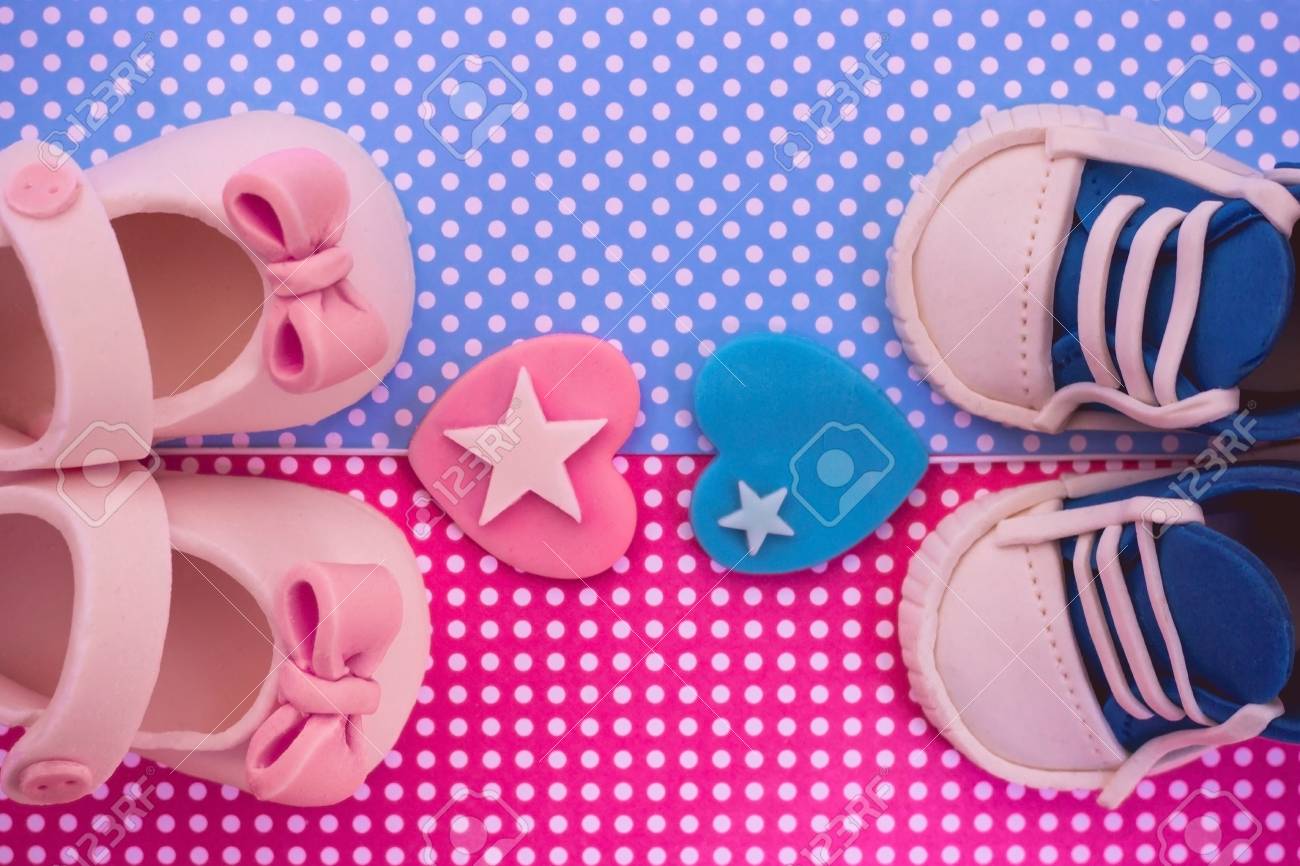 Is It A Boy Or A Girl Concept Girl And Boy Baby Shoes On Blue