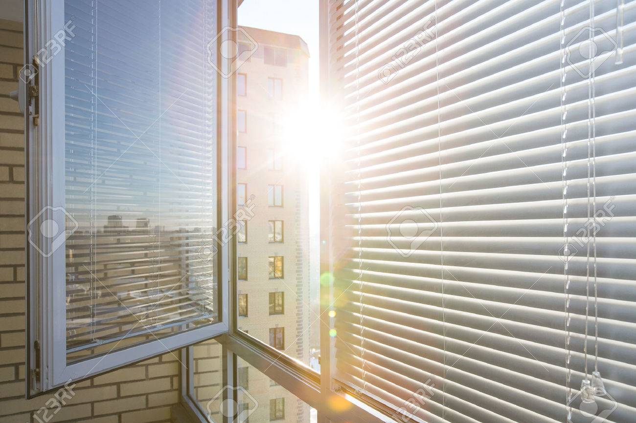 Opened window on sunny day with horizontal plastic blinds - 52823643 Opened window on sunny day with horizontal plastic blinds - 52823643