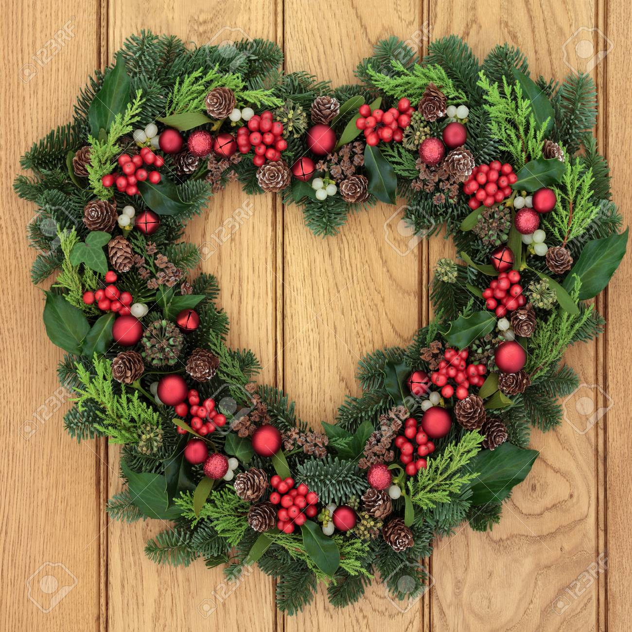 Christmas And Winter Heart Shaped Wreath With Holly Mistletoe