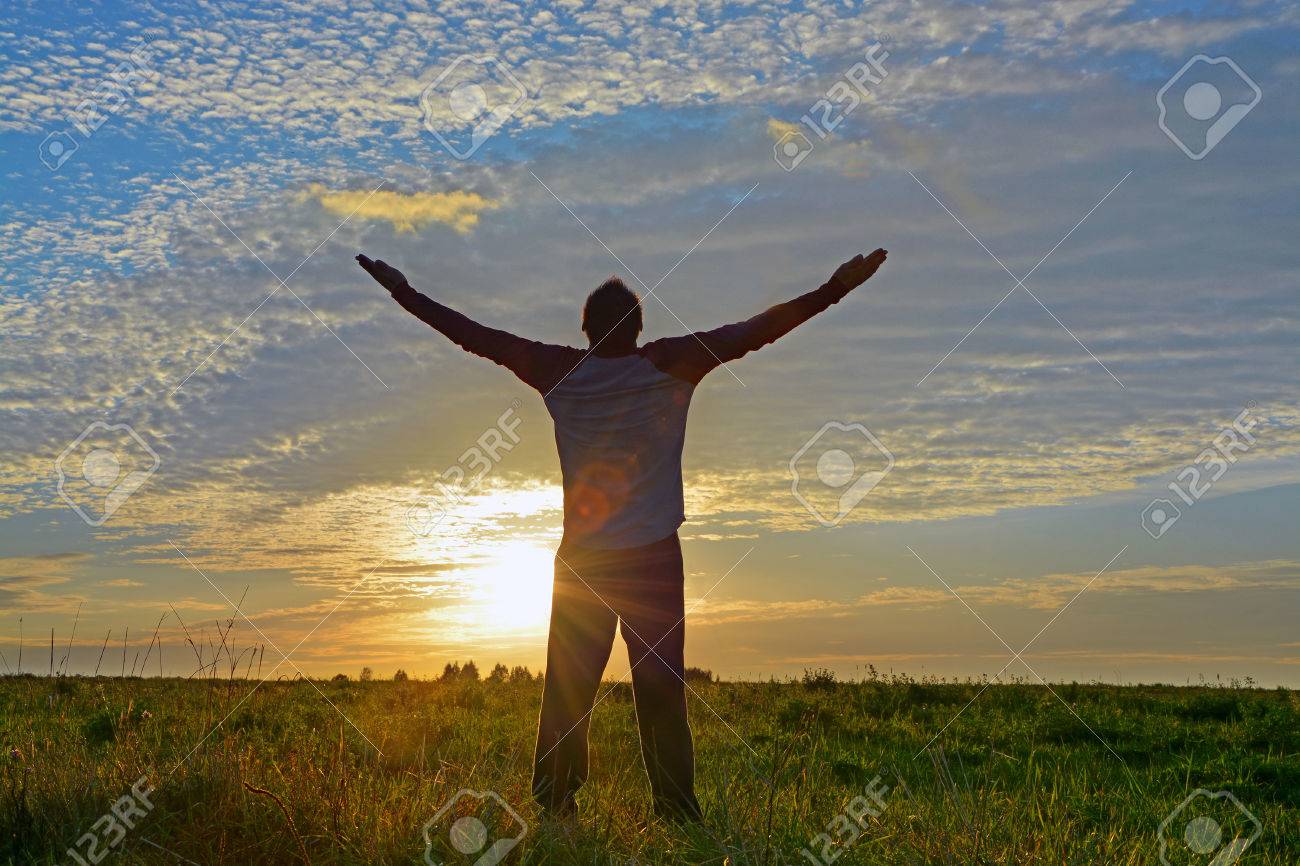 Silhouette of a man with hands raised enjoying his freedom. Concept for religion, worship, freedom - 53591175 Silhouette of a man with hands raised enjoying his freedom. Concept for religion, worship, freedom - 53591175