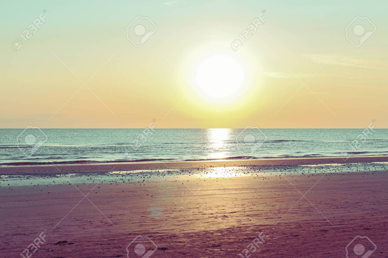 Sunset On The Beach Tinted Photo In Golden Highlights Sea And