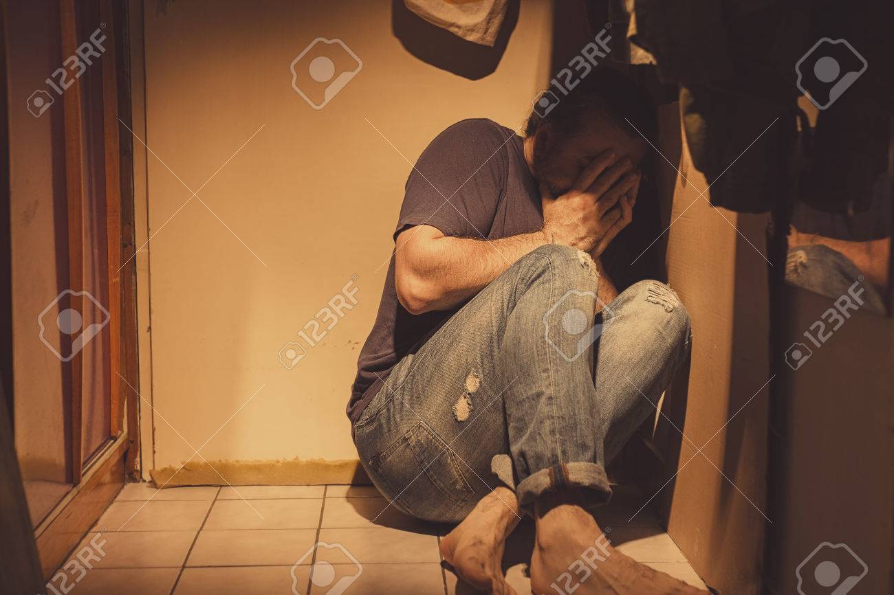 Man Sitting In A Corner Sad Depressed And Lonely Crying Stock Photo Picture And Royalty Free Image Image 82717541