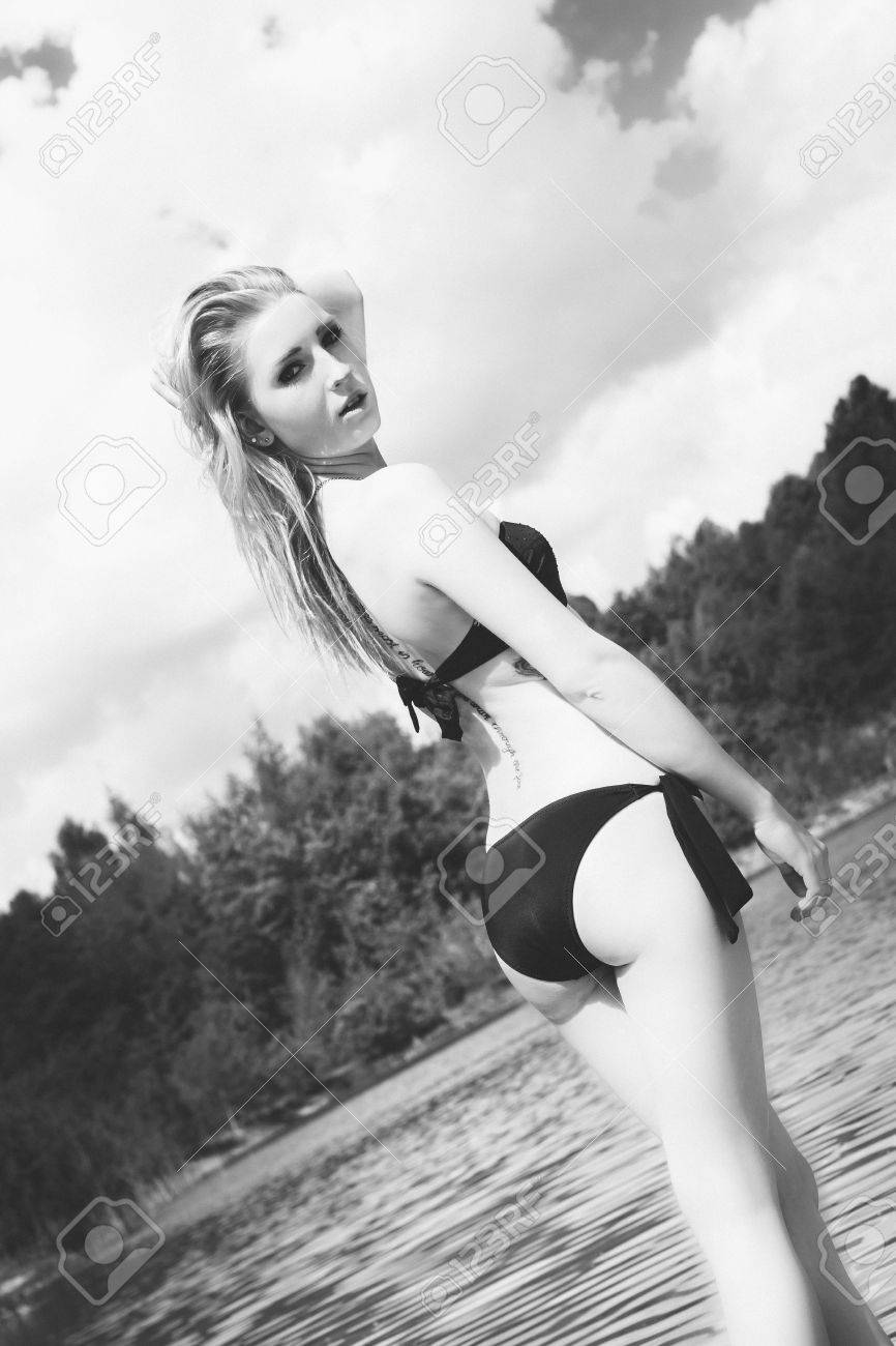Pretty woman in a black bikini in black and white stock photo 58971973