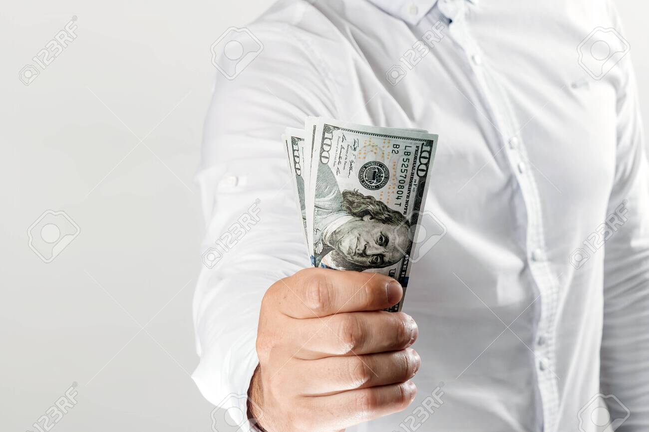 Money in the hands of a businessman, US dollars. The concept of corruption, pledge, bribery, fraud, auction bidding - 122099692 Money in the hands of a businessman, US dollars. The concept of corruption, pledge, bribery, fraud, auction bidding - 122099692