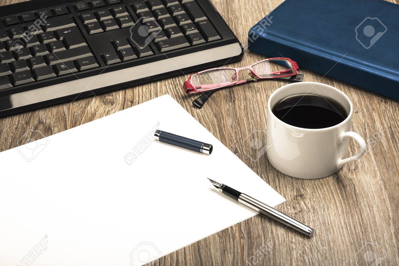 view of an office desk with keyboard calendar coffee cup sheet office desk calendar