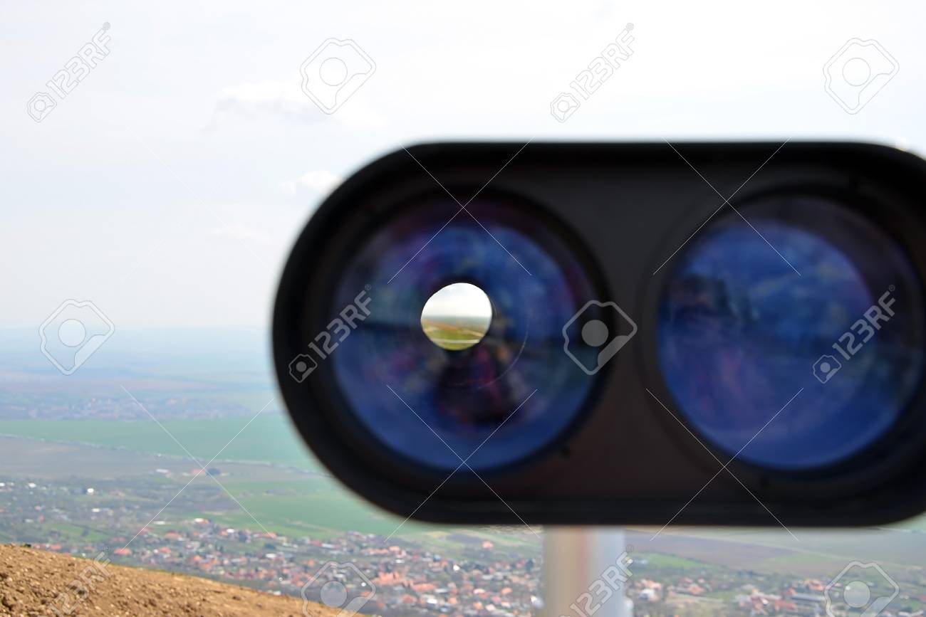 look through binoculars