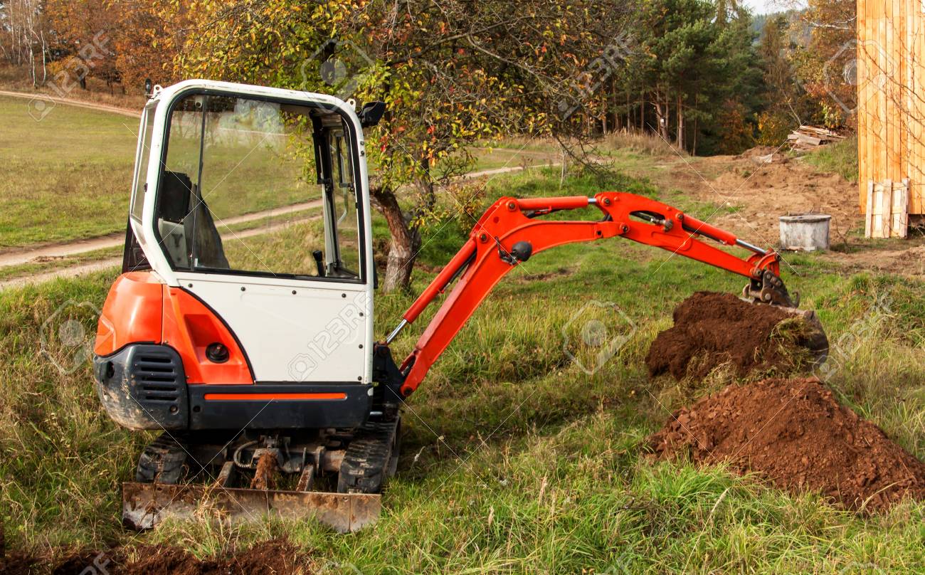 mini excavator on site excavation work the excavator works stock works garden equipment