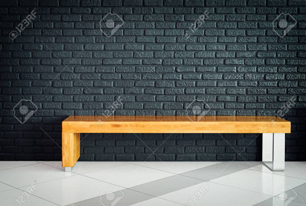 Rectangular Wooden Bench On A Background Of Gray Brick Wall In