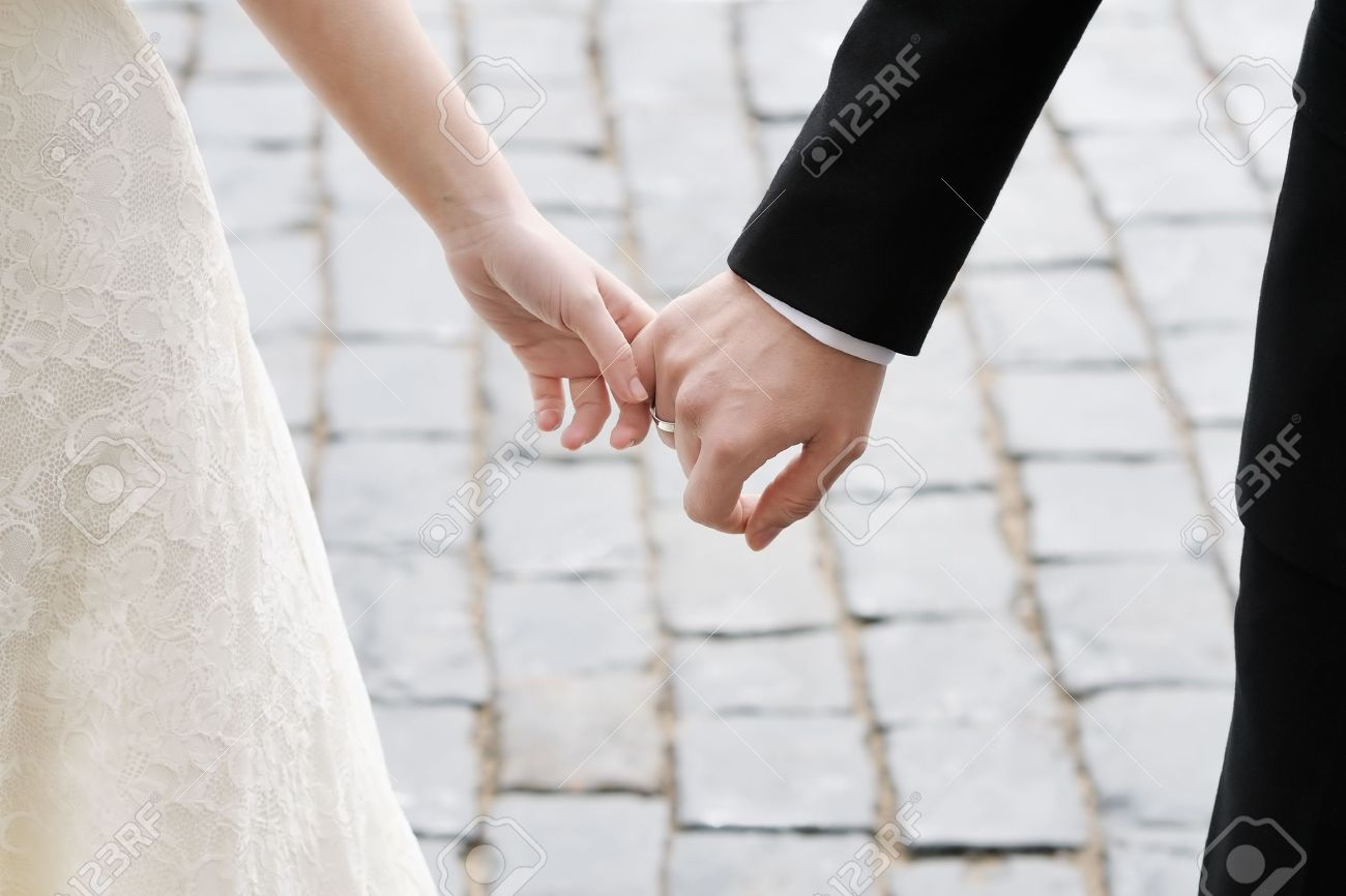 Bride And Groom Holding Hands Outdoors Stock Photo Picture And