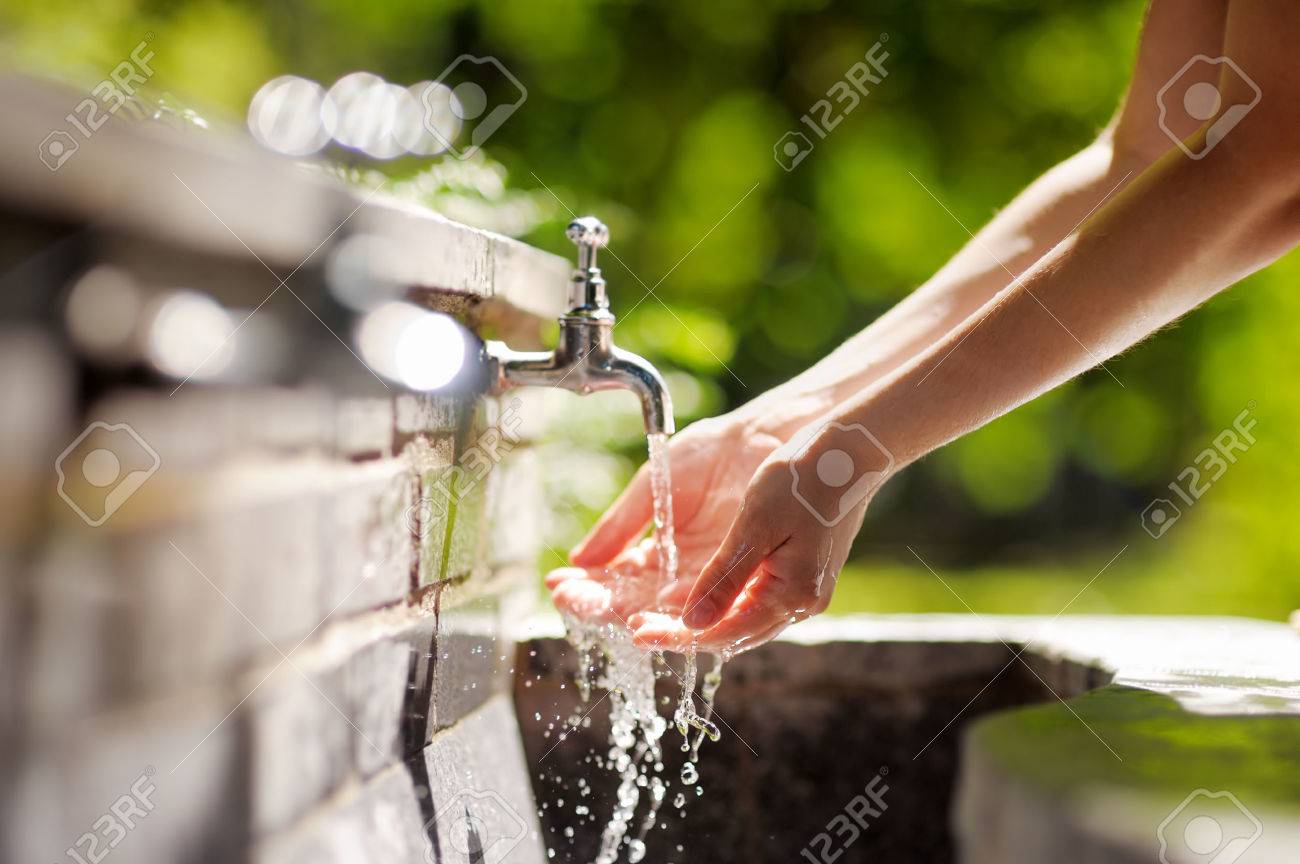 Closeup photo of woman washing hands in a city fountain - 31086674 Closeup photo of woman washing hands in a city fountain - 31086674