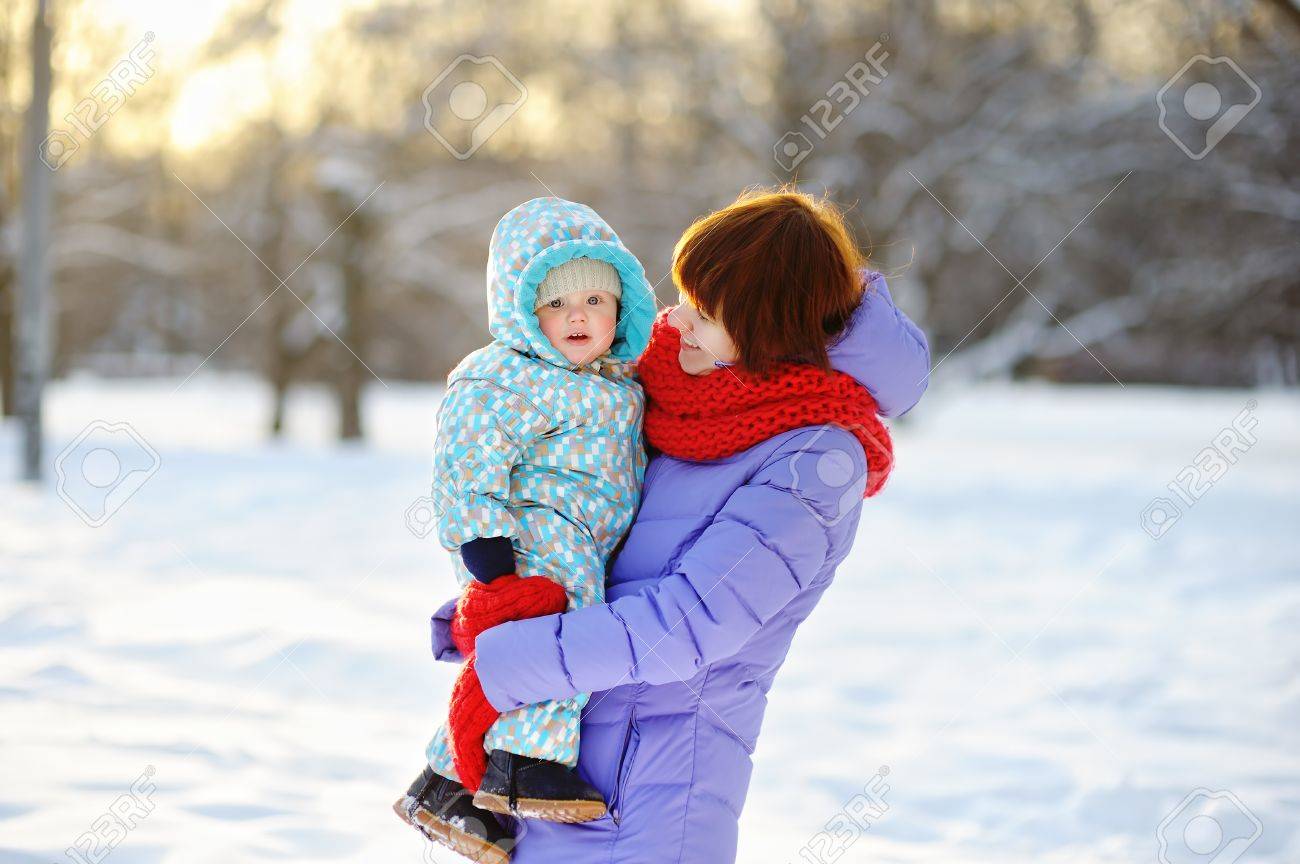 Young woman with her toddler boy at the winter park - 44784262 Young woman with her toddler boy at the winter park - 44784262