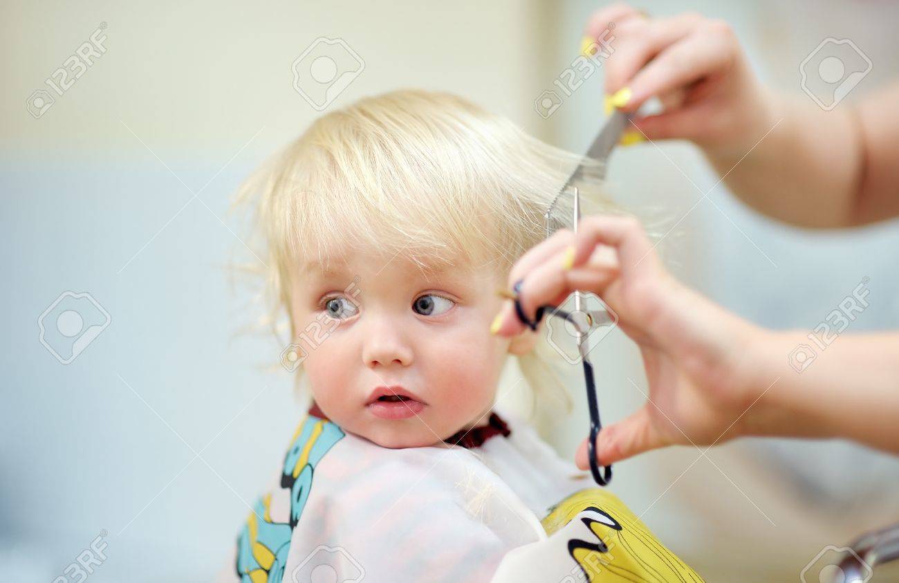 Close up portrait of toddler child getting his first haircut - 47226610 Close up portrait of toddler child getting his first haircut - 47226610