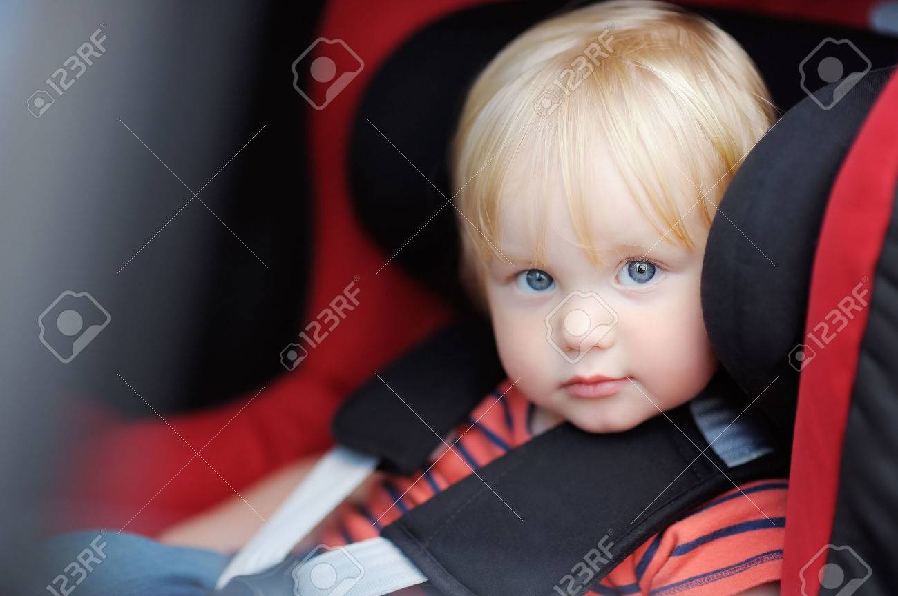 Portrait of toddler boy sitting in car seat - 52905237 Portrait of toddler boy sitting in car seat - 52905237