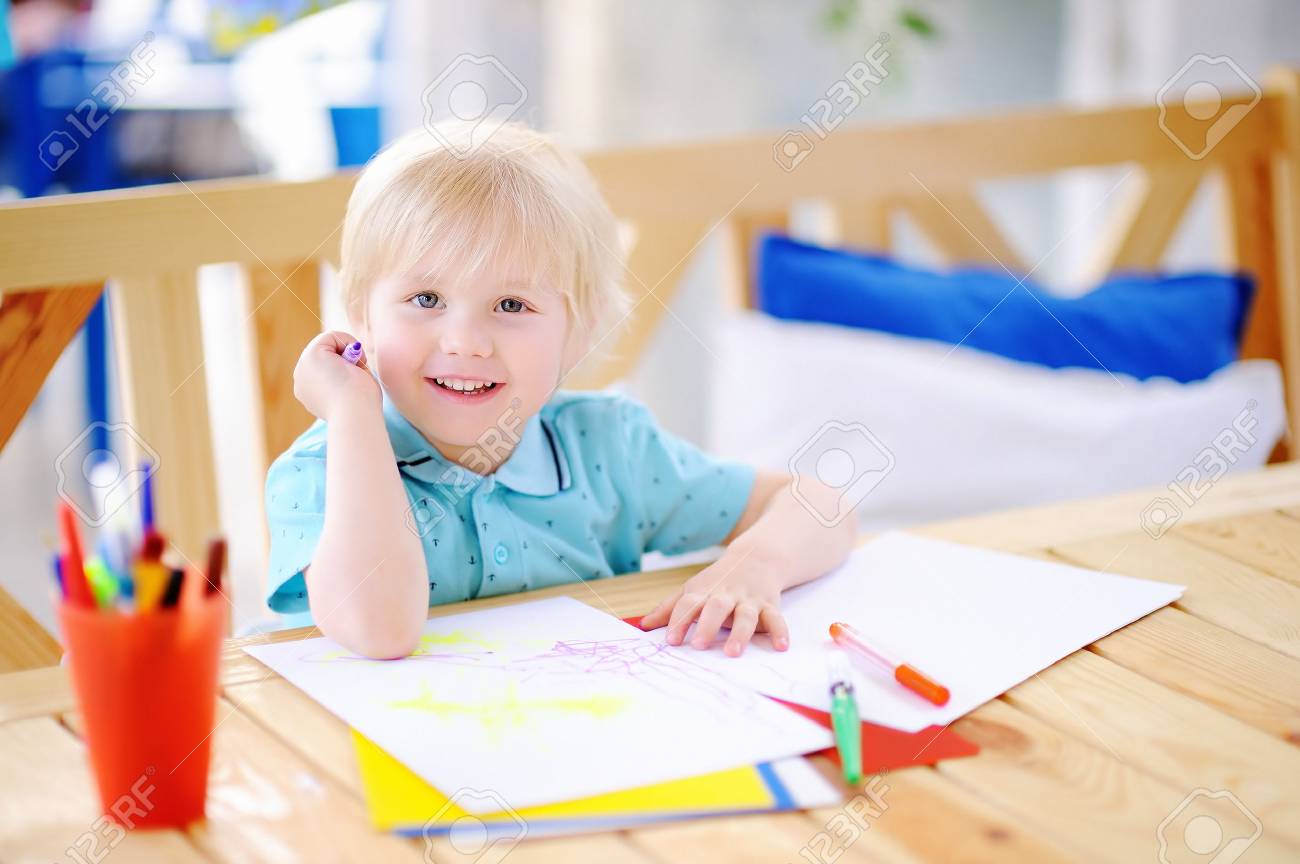 Cute little boy drawing and painting with colorful markers pens at kindergarten. Creative kid painting at playschool. Development toys for preschooler children - 82937357 Cute little boy drawing and painting with colorful markers pens at kindergarten. Creative kid painting at playschool. Development toys for preschooler children - 82937357