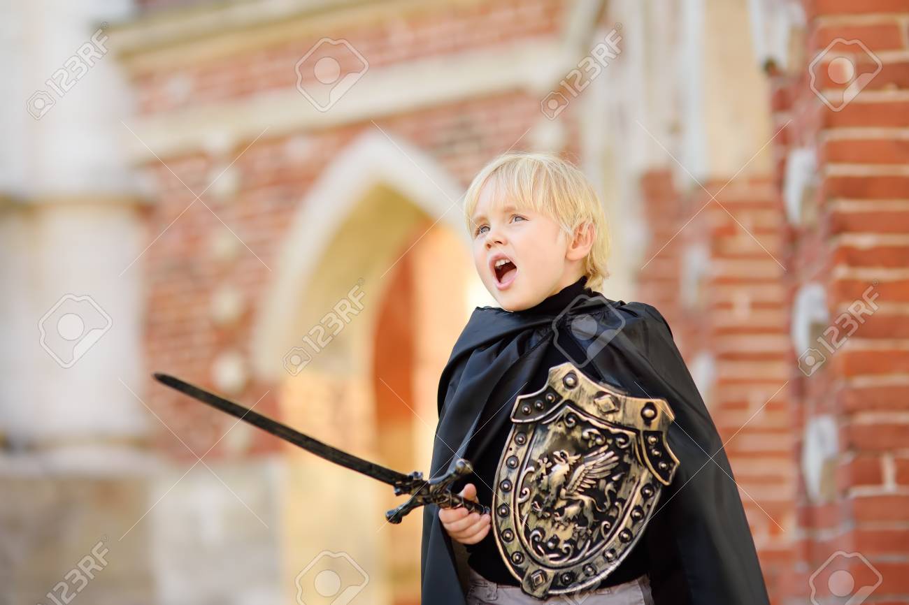 Portrait of a cute little boy dressed as a medieval knight with a sword and a shield. Medieval festival or costume party for kids - 109768272 Portrait of a cute little boy dressed as a medieval knight with a sword and a shield. Medieval festival or costume party for kids - 109768272