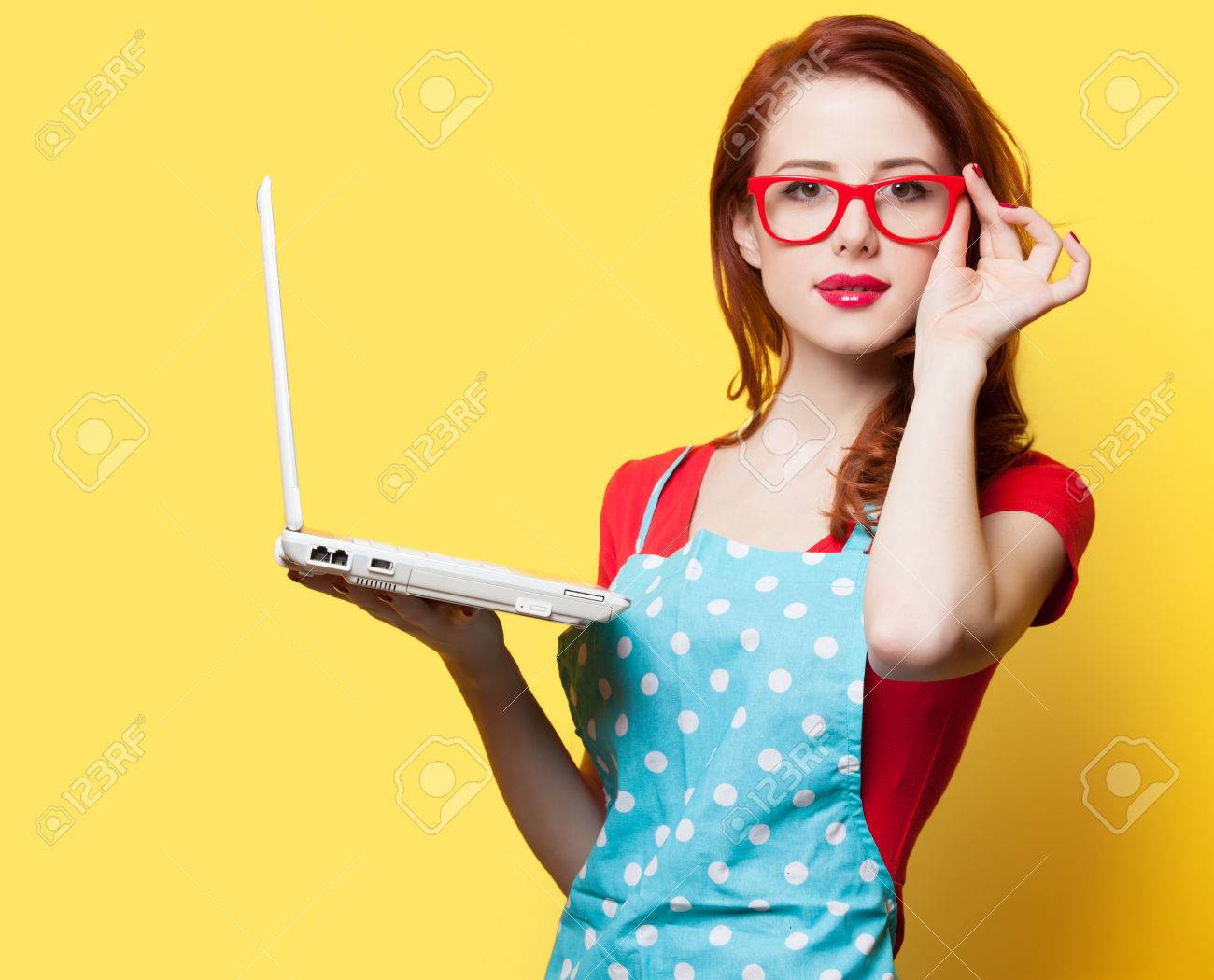 Housewife in glasses with computer on yellow background - 37324374 Housewife in glasses with computer on yellow background - 37324374